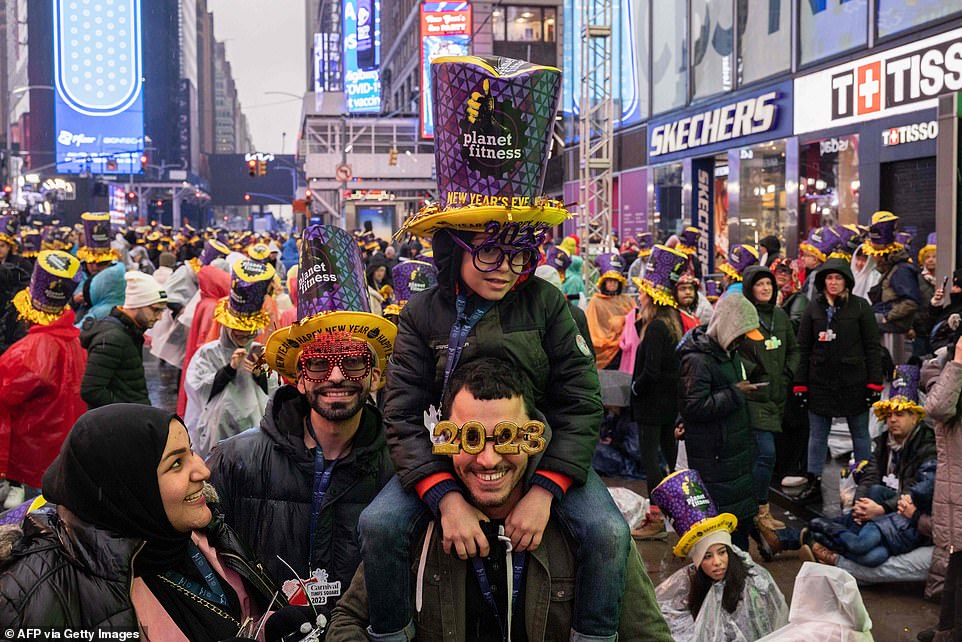 Thousands of revelers have flooded Times Square, where record crowds are expected to celebrate unrestricted New Year's Eve under a blanket of fog and rain after two years of celebrations blighted by the pandemic.