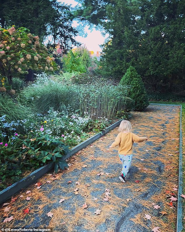 Baby mine: One of the most moving images, however, was of her two-year-old son, Rhodes, running ahead of her down a path covered in autumn leaves.