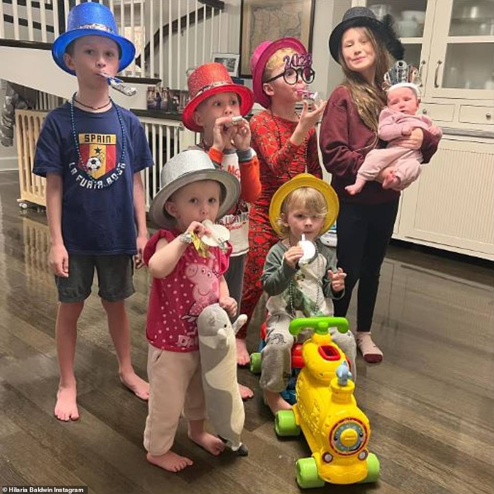 Happy bunch: Hilaria Baldwin shared a sweet snap of her and Alec Baldwin's seven children as they posed at home dressed in horned party hats and plastic musical glasses