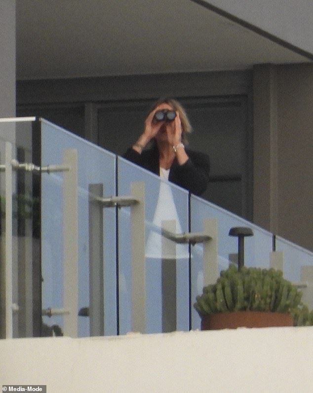 At one point, the singer was seen looking through binoculars on his balcony.