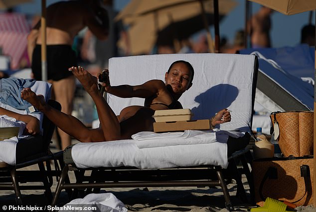 Sunscreen?  Tran also made sure to take care of her skin with what appeared to be a sunscreen that he applied to her long legs.