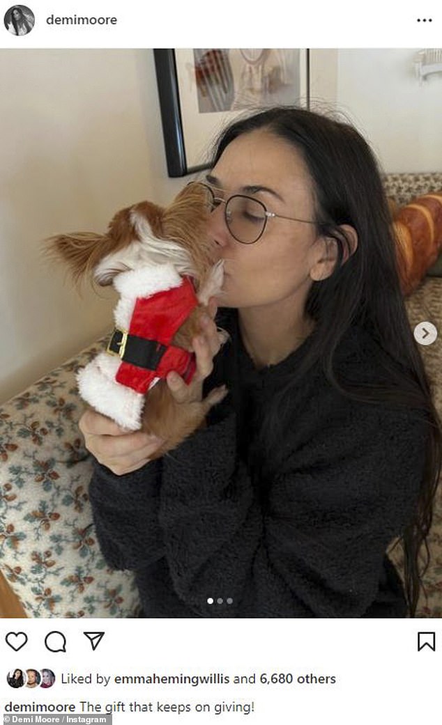 Adorable: Earlier this week, while spending the holidays with her daughter Tallulah, Moore posed for a photo with her beloved dog