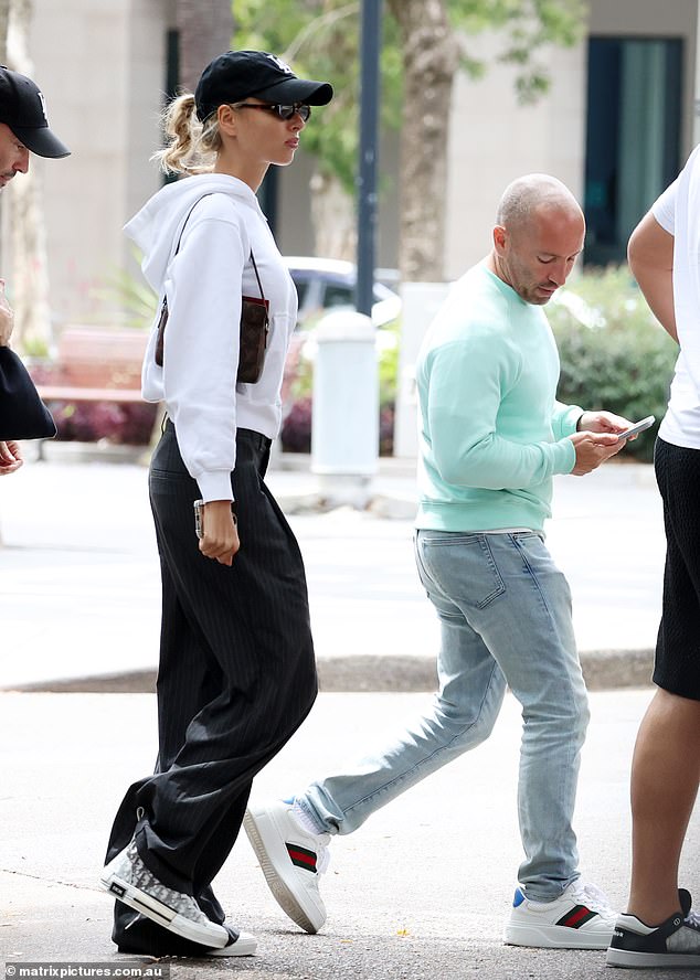 She completed her look with Dior sneakers and a low-waisted cap.