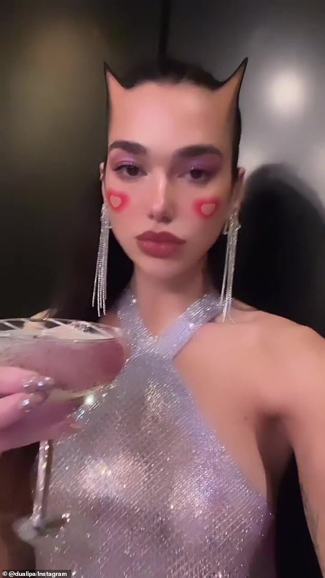 Eye-catching: At the top of the short clip posted to her Instagram Stories, Lipa stared directly into the camera looking every inch the party girl in a beaded silver halter-neck dress