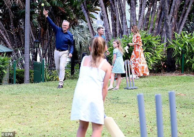 Anthony took off his jacket and enthusiastically struggled with the children.