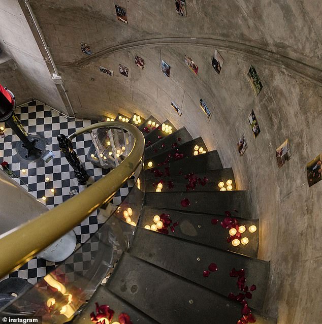 The former reporter for the Canberra Press Gallery draped the interior steps of the lighthouse with candles, rose petals and photos of the couple (pictured)