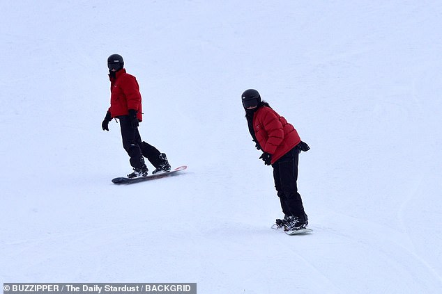 Covered!  Kendall was almost unrecognizable as she donned a black North Face snowsuit to keep warm.