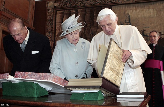 Queen Elizabeth II speaks with Pope Benedict XVI exchanging gifts during an audience in the Morning Drawing Room of the Palace of Holyroodhouse in Edinburgh, September 2010