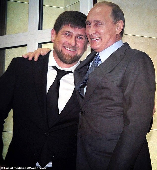 Akin was handed over to the special services before volunteer Yuriy Kovanov presented him to Ramzan Kadyrov (left) as a 