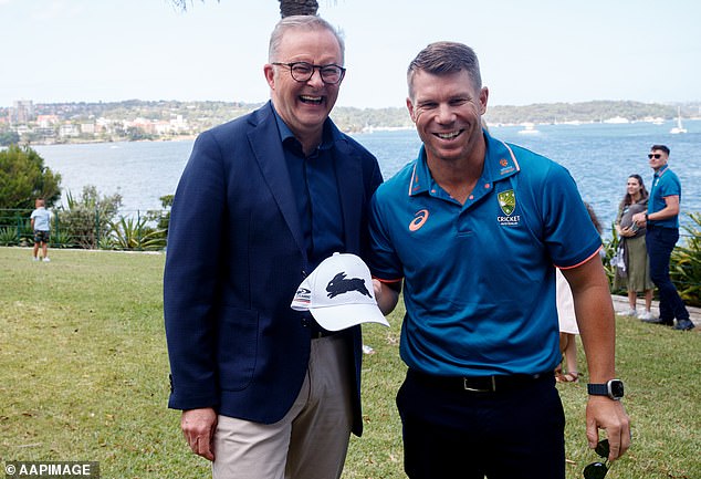 David holding his new Rabbitoh cap and the PM posed side by side with a stunning view of the water in the background.