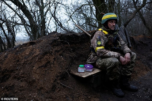 Ukrainian military soldier sits before preparing to fire a mortar, as Russia's attack on Ukraine continues in the Donetsk region.