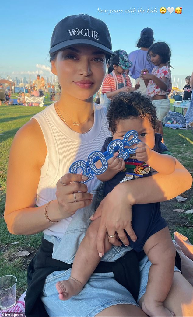 The mother-of-one seemed delighted to ring in the New Year in style.  Pictured: Shanina and her three-month-old son Zai.