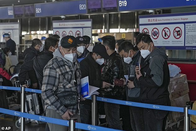 Scientific advisers have said that mandatory testing of arrivals from China will not make much of a difference to the UK and have said it is not a priority.  Pictured: Masked travelers check in at the Beijing Capital International Airport on December 29, 2022.