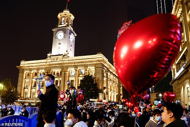 People hold balloons as they gather to celebrate New Year's Eve, amid the coronavirus disease (COVID-19) outbreak, in Wuhan, Hubei province, China, December 31, 2022.