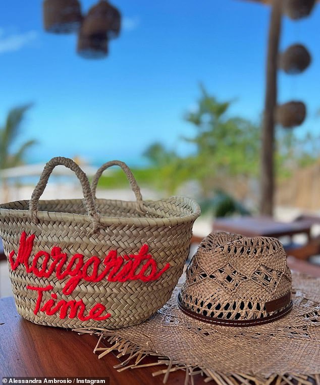 What time is it?  The star accessorized her cute vacation outfit with a basket bag that she had embroidered 