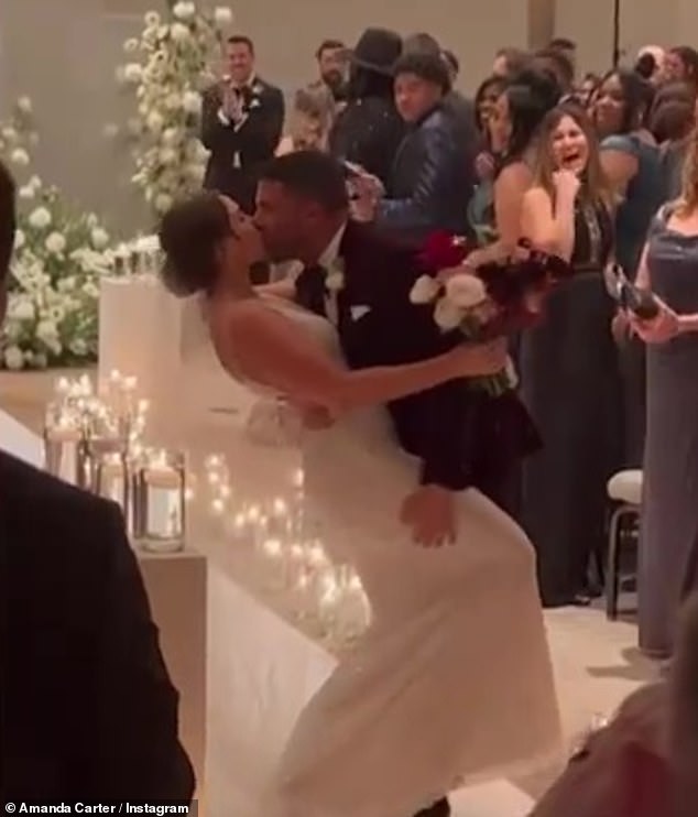 Dip: The couple delighted their guests when a kiss down the hall turned into a romantic dip