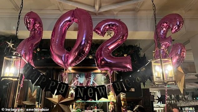 Other photos showed Amelia taking photos of what appeared to be a bar set to celebrate the start of 2023 with its patrons holding banners and drinks.