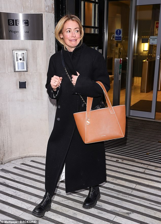 All smiles: She rocked a pair of black leather boots with zips up the front as she smiled for the cameras as she left the building