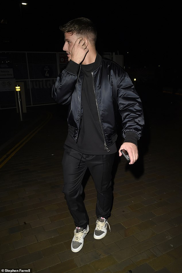 Laid back: Luca rocked a black satin bomber jacket, over a black t-shirt and matching pants