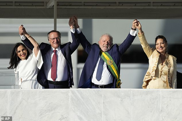 Lula was seen standing with his wife Rosangela Silva (right) and Vice President Geraldo Alckmin (second from left).  Alckmin's wife, Maria Lucia Ribeiro, was also present (far left)