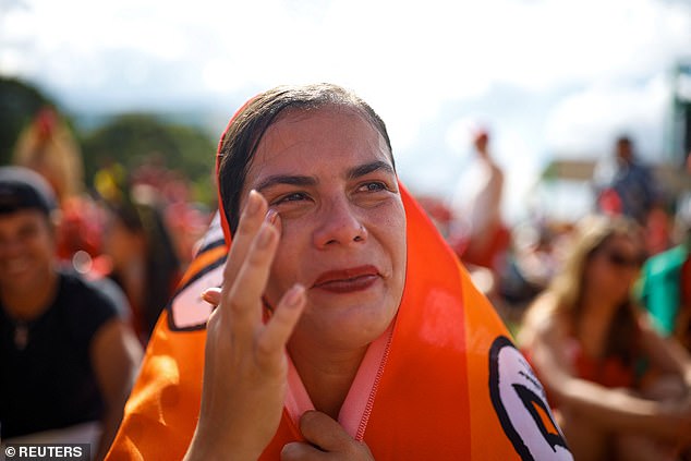 A woman was seen wiping off her tea while looking at Lula.