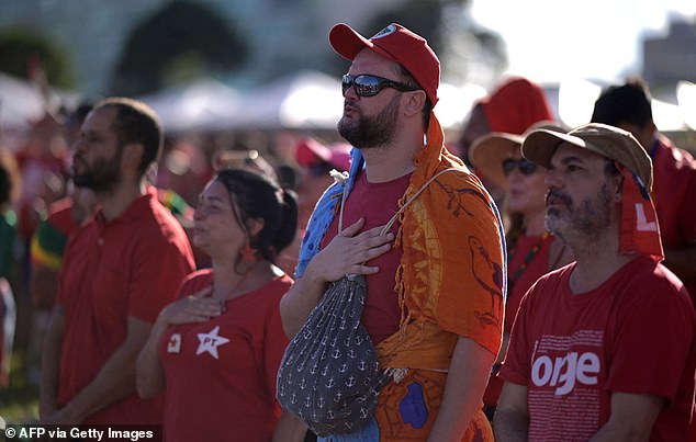 Supporters were seen with their hands over their hearts as they listened to the national anthem.