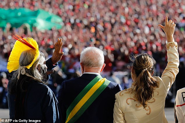 Lula (center) was seen standing with his wife (right) and Metikire (left)