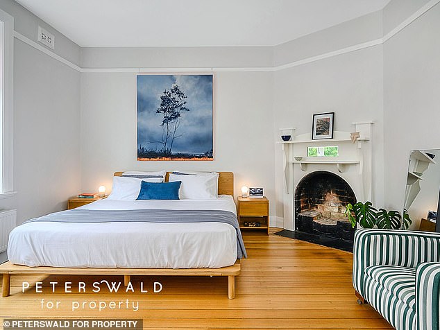 There's also a sunny, covered patio, polished hardwood floors throughout, a light-filled sunroom, and a stunning master bedroom overlooking the tree-lined street below.