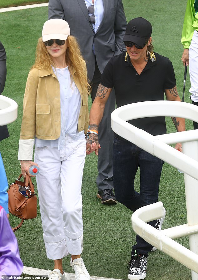 The Hollywood actress and musician, both 55, held hands and hugged as they enjoyed a fun day at the races.