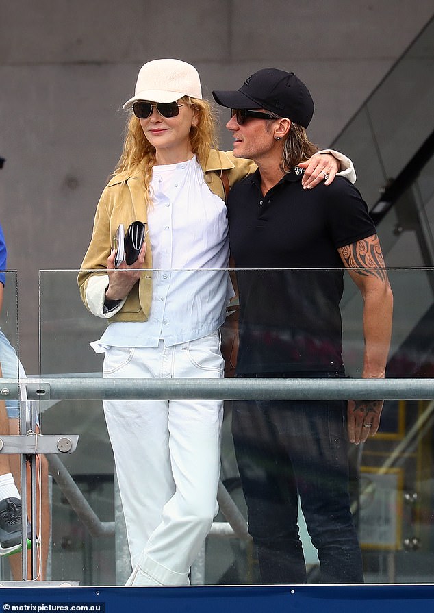 Nicole wrapped her arms around her husband of 16 years as she watched the races from the stands.