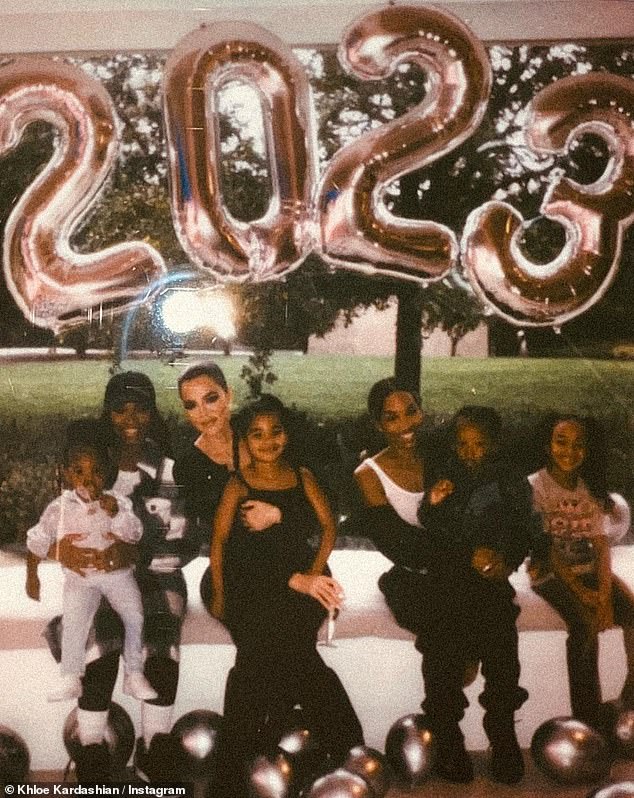 Girls night out: Khloe sat next to two of her friends, Khadijah Haqq McCray (@foreverkhadijah) and Malika (@malika), who posed with their daughter on her lap under large silver balloons floating overhead that spelled 