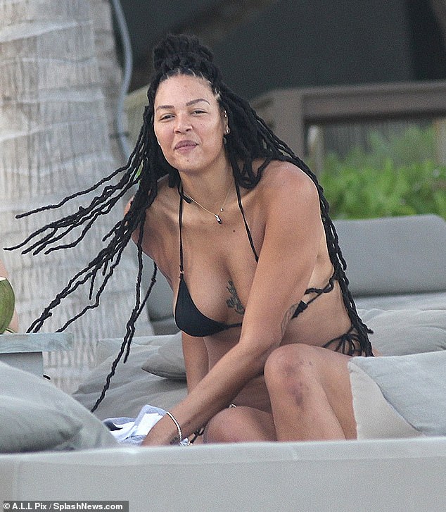 The no-makeup glam left little to the imagination in her skimpy strappy bikini, which featured a triangle-style top and a thong bottom.