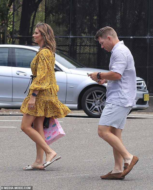 Candice showed off her legs in a frilly yellow dress embellished with a black print and silver sandals.