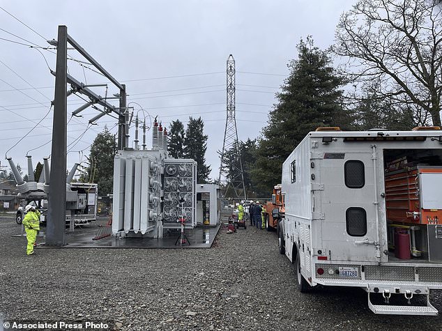 A Tacoma Power crew works on a vandal damaged electrical substation early Christmas morning