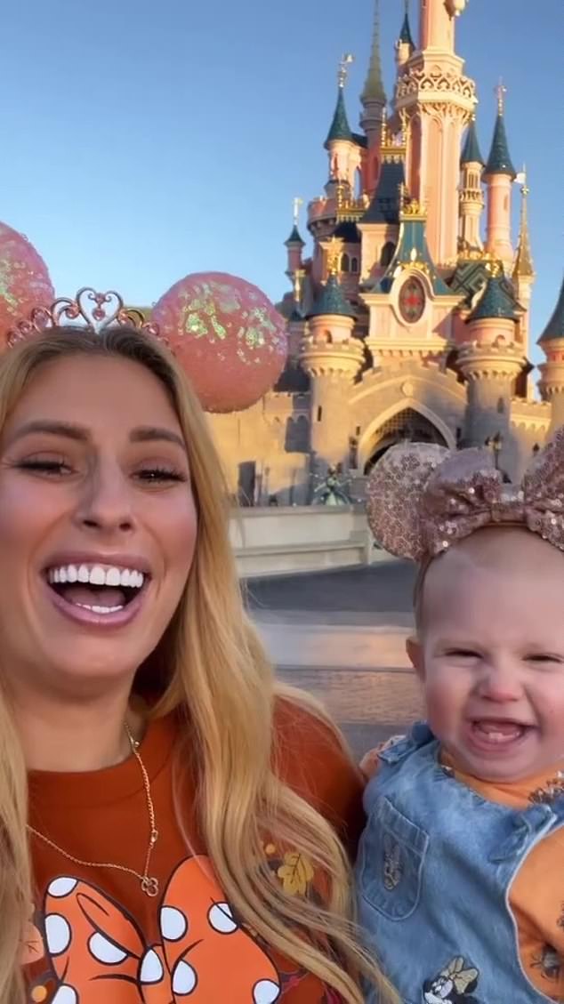 Twinning: The family was seen having fun in October at Disneyland Paris as they posed in front of Cinderella's castle with dazzling pink Mickey Mouse ears