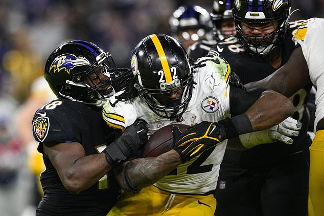 Pittsburgh Steelers running back Harris is tackled by Roquan Smith (18) and Travis Jones (98)
