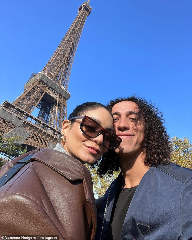 Je t'aime: Hudgens and her baseball player boyfriend Cole Tucker shared a hug in front of the Eiffel Tower in Paris in November