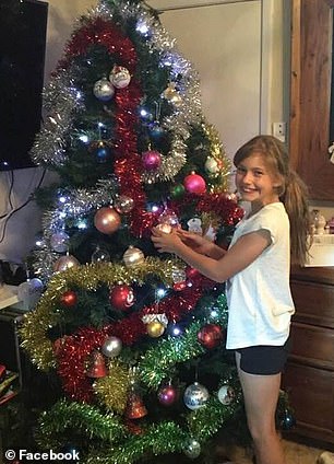 Lily Van de Putte pictured helping to decorate the family Christmas tree in 2019