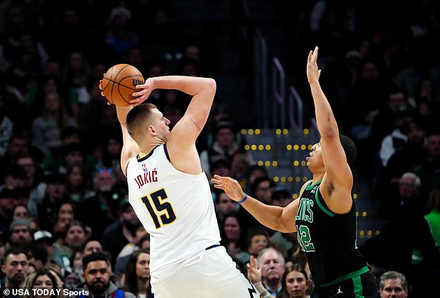 Jokic (15) prepares to throw the ball over Boston Celtics forward Grant Williams (12)