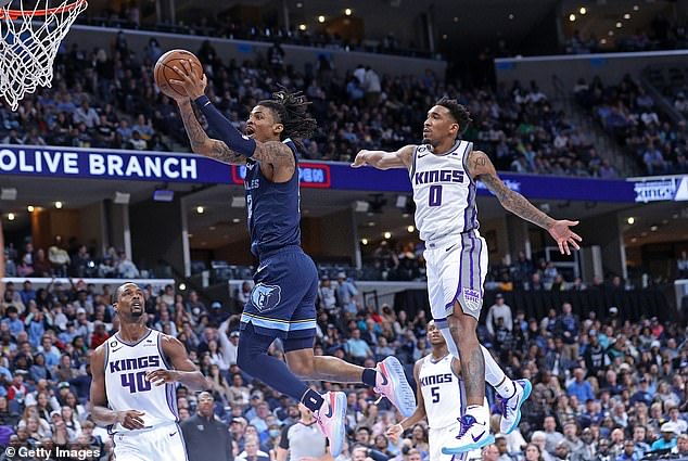 Ja Morant goes to basket during the second half against Malik Monk (0) of the Kings