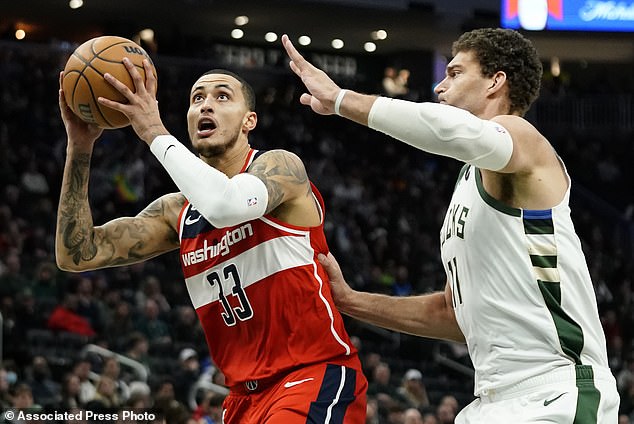 Kyle Kuzma (33) of the Washington Wizards drives to the basket against Brook Lopez of Milwaukee