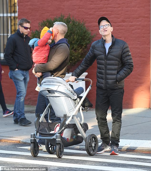 Holding his son: The France native held his two-year-old son Wyatt, who was wearing a bright red and blue jacket