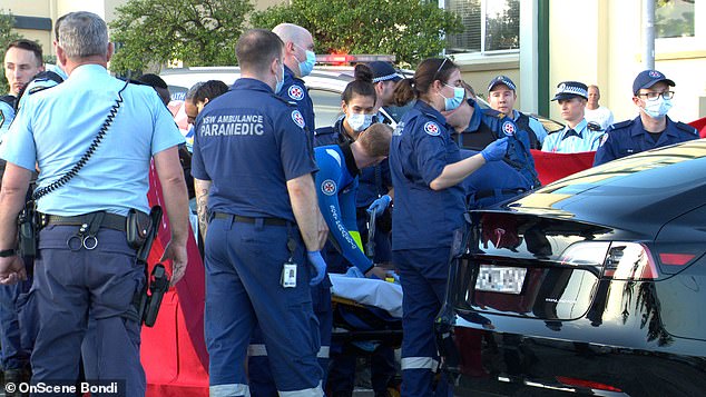 After 25 minutes of CPR, the baby regained consciousness and began to cry.  Paramedics transferred the baby to a stretcher before taking him to the hospital (pictured)