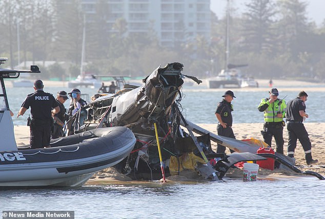 Police officers are shown at the scene of a crash between two helicopters on Monday afternoon.