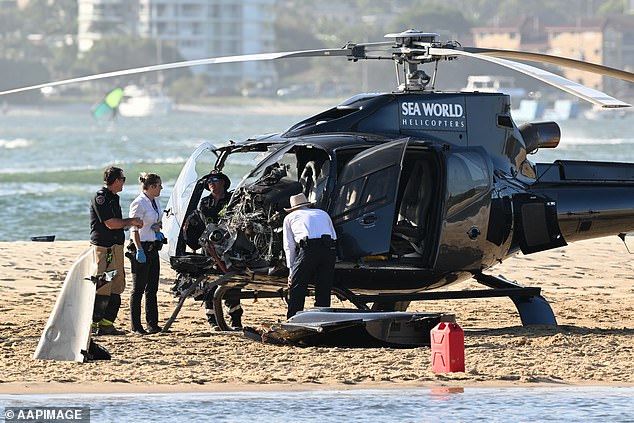 In the photo, investigators look at the damage done to one of the two crashed helicopters.