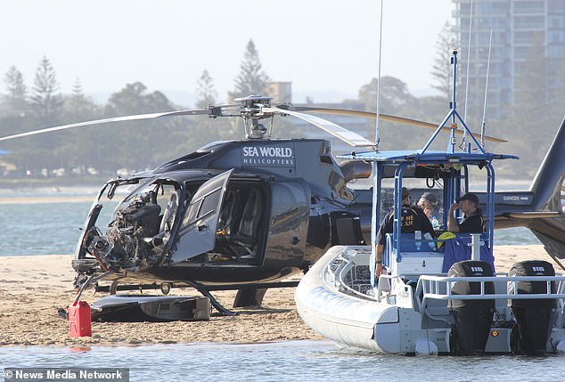 A rescue boat is pictured next to one of the crashed helicopters off Queensland's Gold Coast.