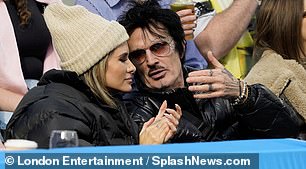 Lovebirds: In matching black puffer jackets, Lee and Furlan kept close and seemed very much in love when the rock star wasn't screaming on the field