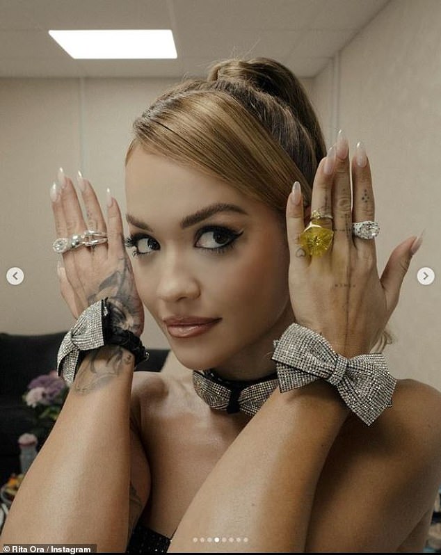 Dressed to impress: Rita turned up the heat by accessorizing with a matching bowknot choker and two matching bracelets.