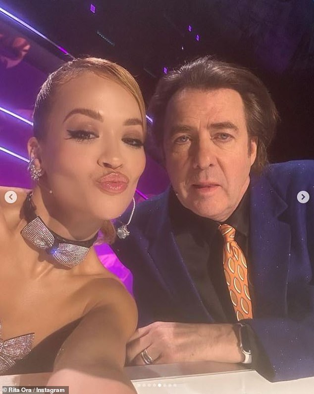 Selfie!  Rita posed for a selfie at the panel with her fellow judge Jonathan Ross, 62, who cut a dashing figure in a black suit and bright yellow tie.