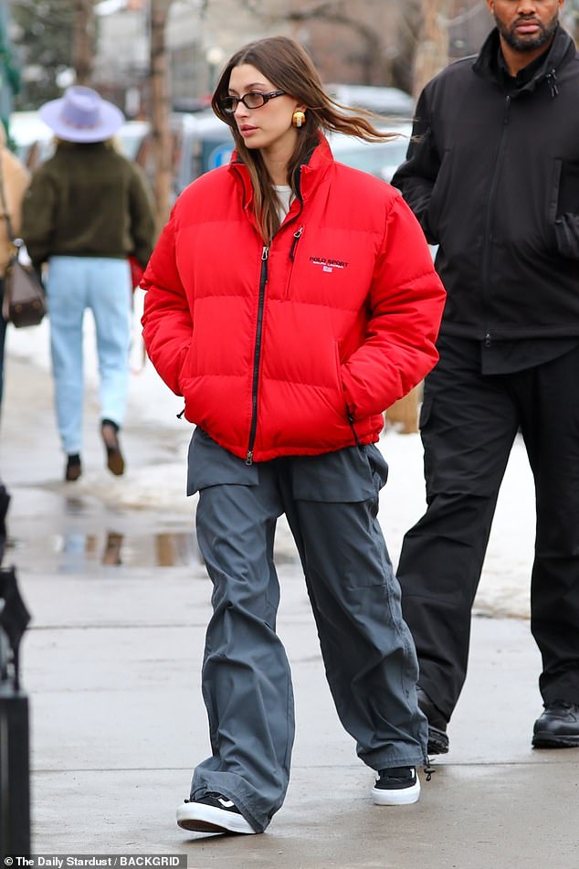 Style: She completed her understated look with black Vans sneakers and added a pair of yellow tinted sunglasses and statement gold earrings.